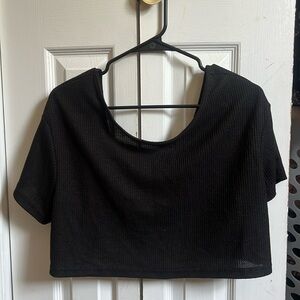 a cropped shirt with open back .